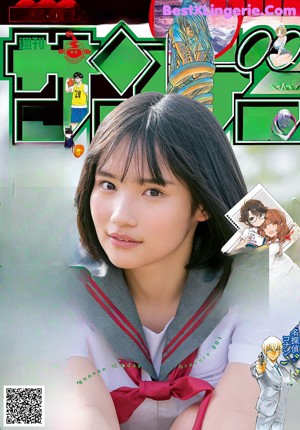 A woman in a blue shirt is posing for a magazine.