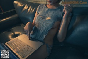 A woman in a blue underwear is sitting on a couch.