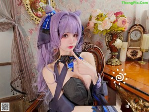 A woman with long purple hair holding a bouquet of flowers.