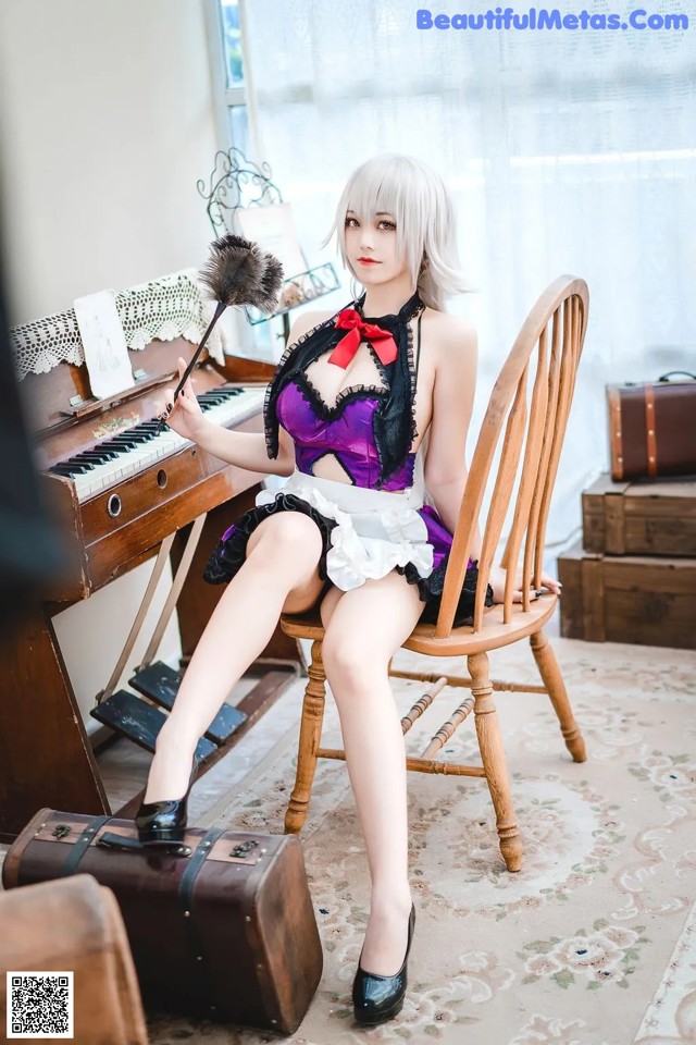 A woman sitting on a chair in front of a piano.