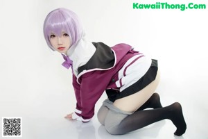 A woman in a school uniform is laying on a bed.