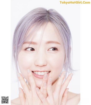 A magazine with a picture of a woman with purple hair.