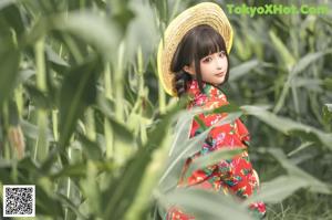 A naked woman holding a pumpkin on her head in a field.