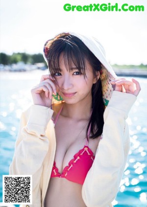 A woman in a pink bikini on the cover of a magazine.