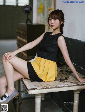 A magazine spread with a picture of a woman sitting on the floor.