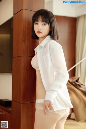 A woman in a school uniform posing for a picture.