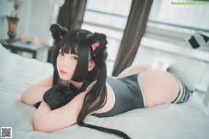 A woman sitting on a chair holding a teddy bear.