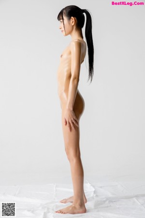 A woman in a white thong is posing for the camera.