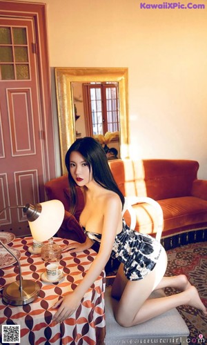 A woman sitting at a table with a cup of coffee.