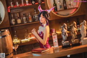 A woman in a bunny costume sitting on a chair.