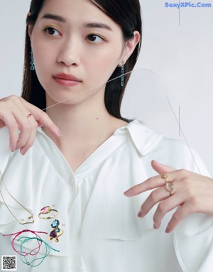 A magazine page with a picture of a woman with different hairstyles.