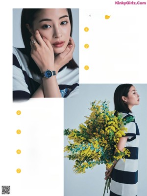 A woman standing in front of a wall of paper flowers.
